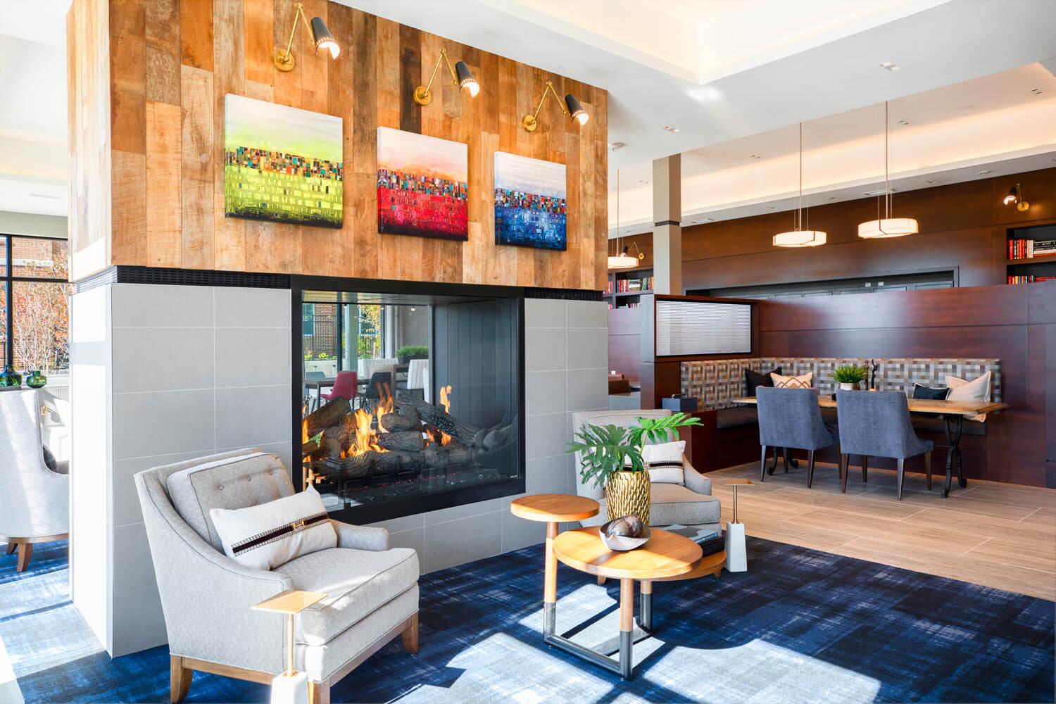 Cozy fireplace with soft seating to welcome you home in our grand lobby | Dartmoor Place